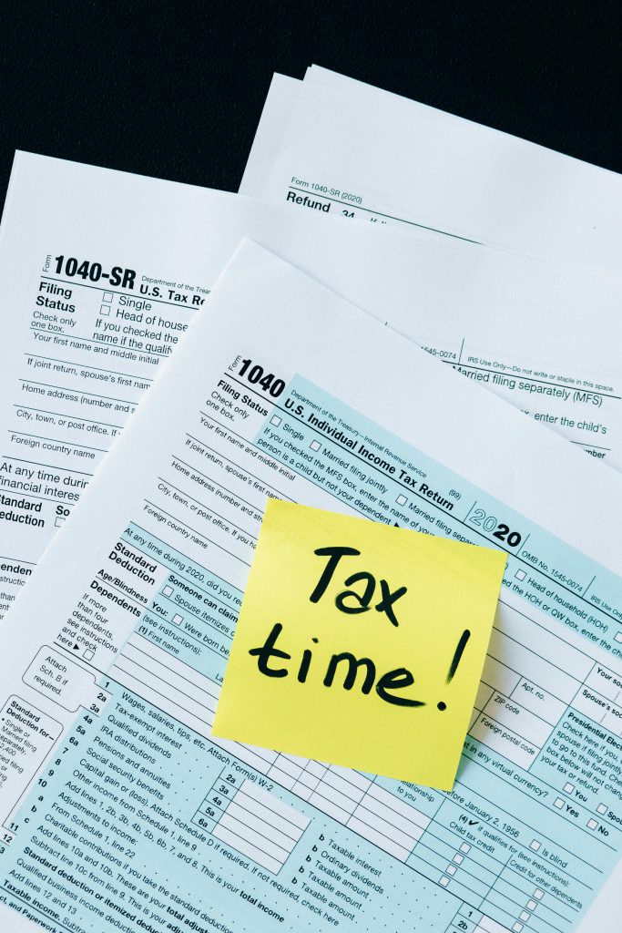 IRS 1040 tax forms with handwritten 'Tax Time!' note for filing reminder.